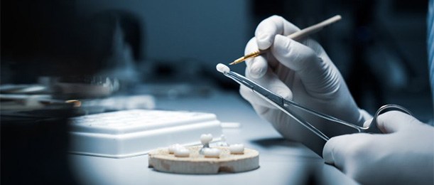 Technician crafts artificial teeth