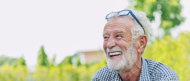 Man smiles outdoors